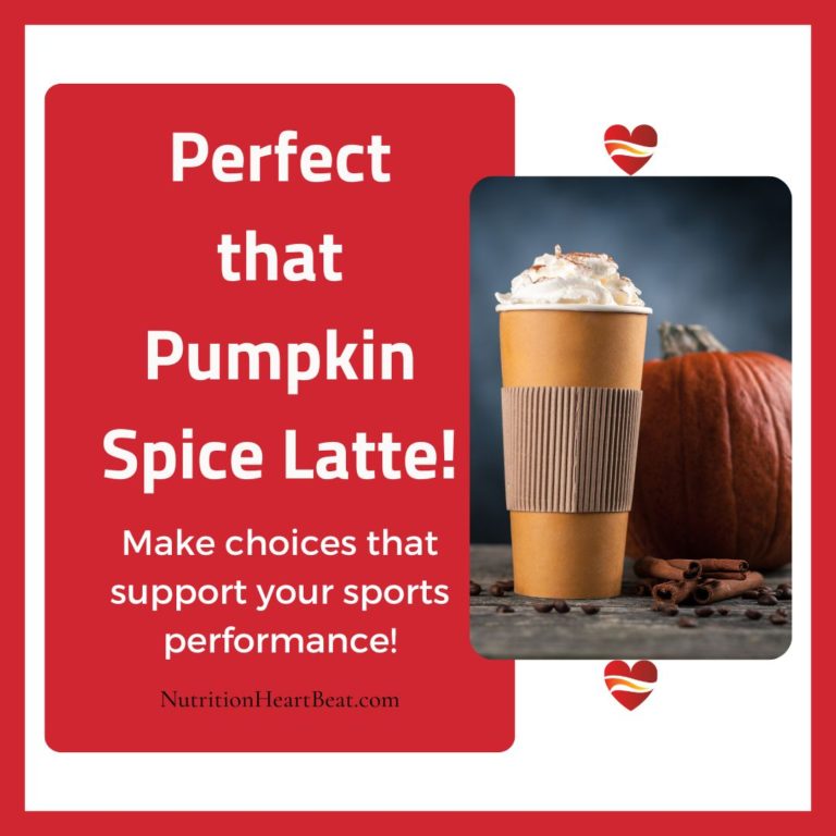 A hot drink in a large to-go paper cup stands in front of a dark orange pumpkin with cinnamon sticks and coffee beans in the foreground.